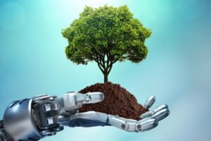 A robot hand holding a small tree in a clump of dirt.